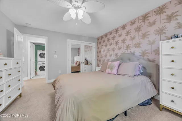 a bedroom with a bed and a mirror on dresser