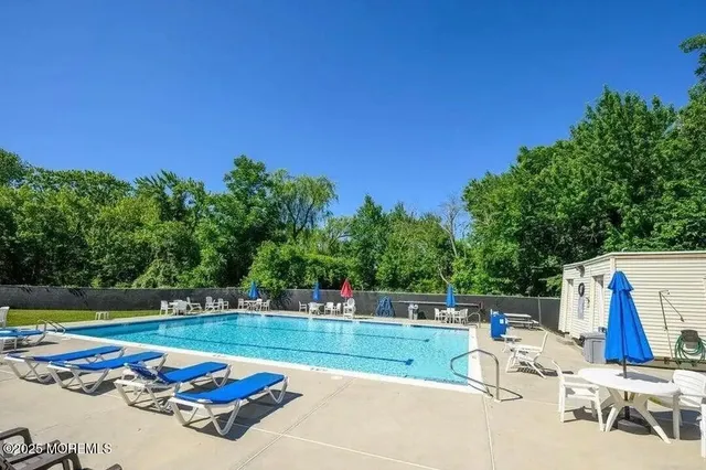 a view of swimming pool with lounge chair and dinning table
