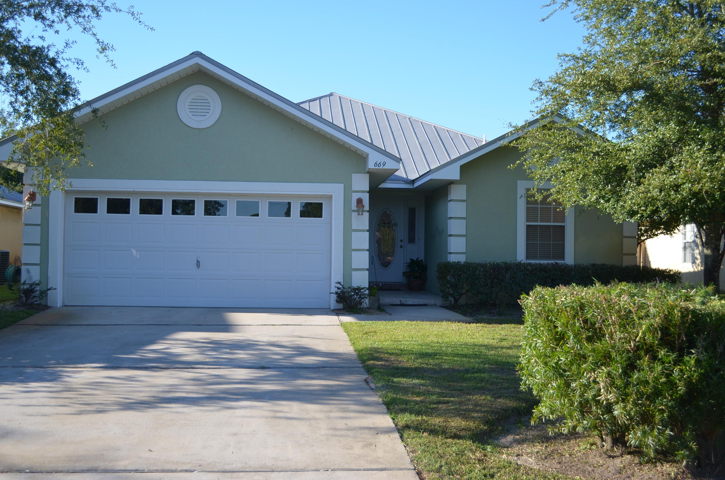 669 East Shipwreck Road Santa Rosa Beach, FL 32459 - Photo 1 of 35 a front view of a house with garden