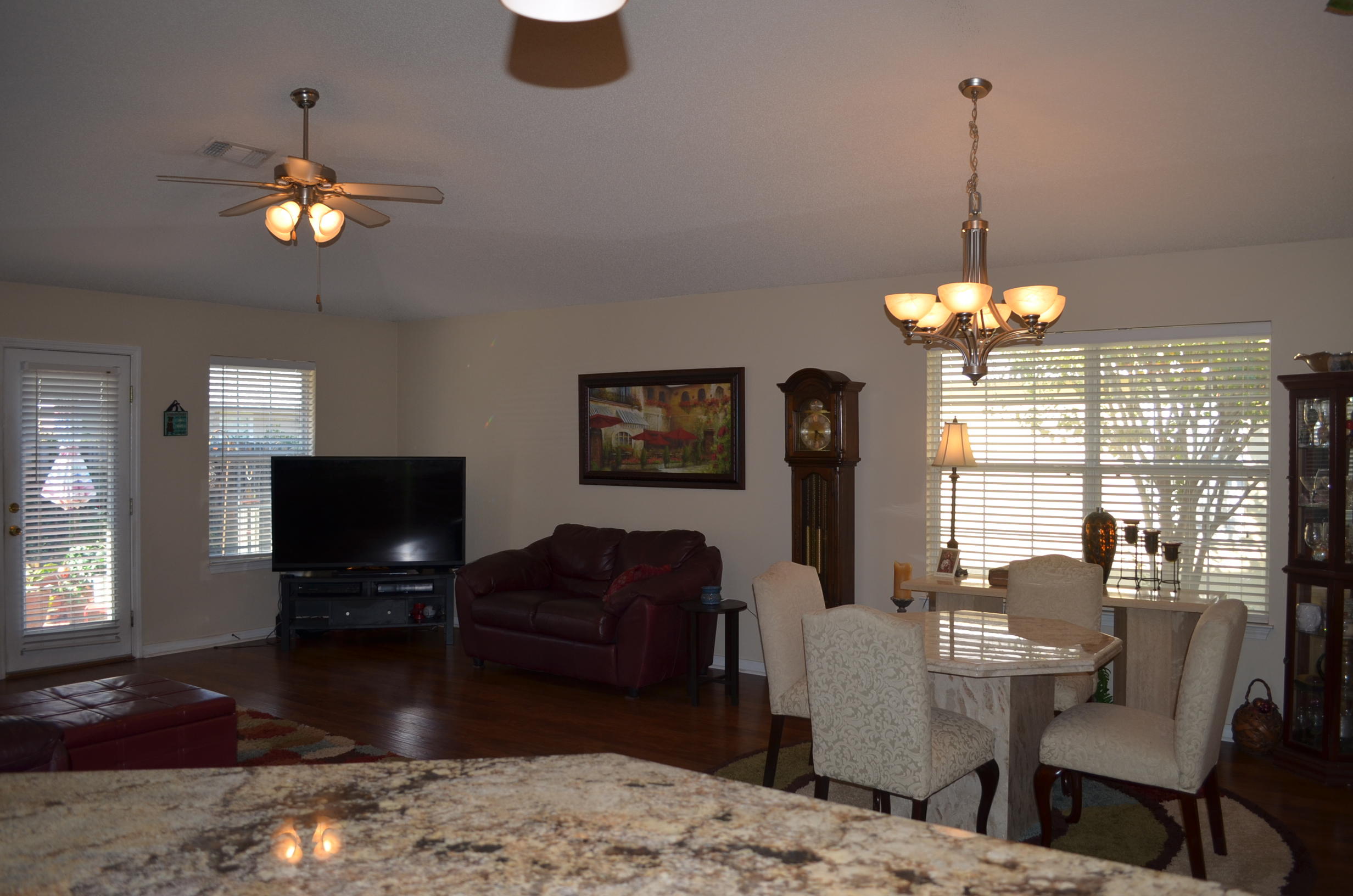 669 East Shipwreck Road Santa Rosa Beach, FL 32459 - Photo 10 of 35 a living room with furniture a chandelier and a flat screen tv