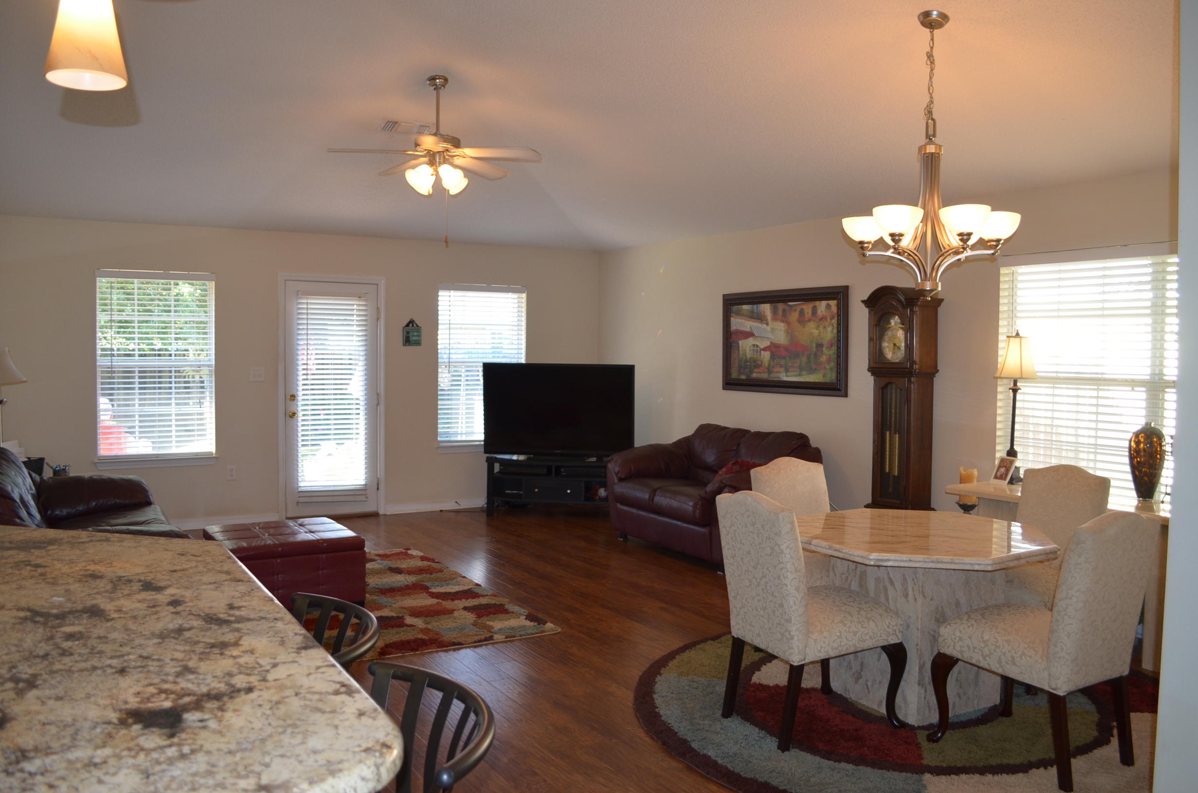 669 East Shipwreck Road Santa Rosa Beach, FL 32459 - Photo 11 of 35 a living room with furniture a chandelier and a flat screen tv