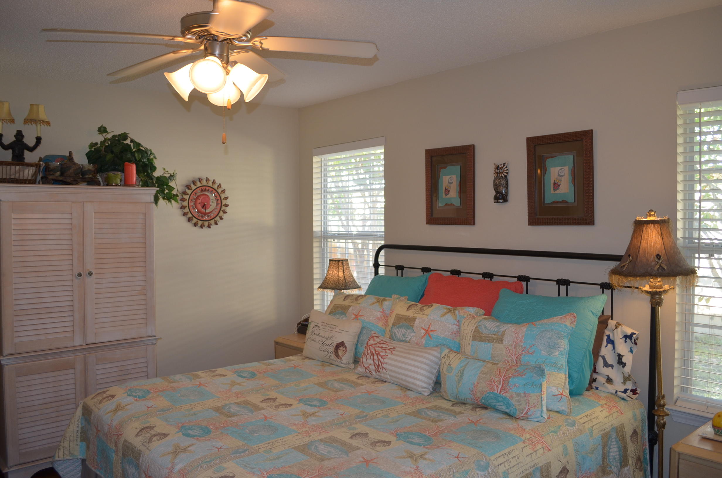 669 East Shipwreck Road Santa Rosa Beach, FL 32459 - Photo 14 of 35 a bedroom with a bed and a chandelier