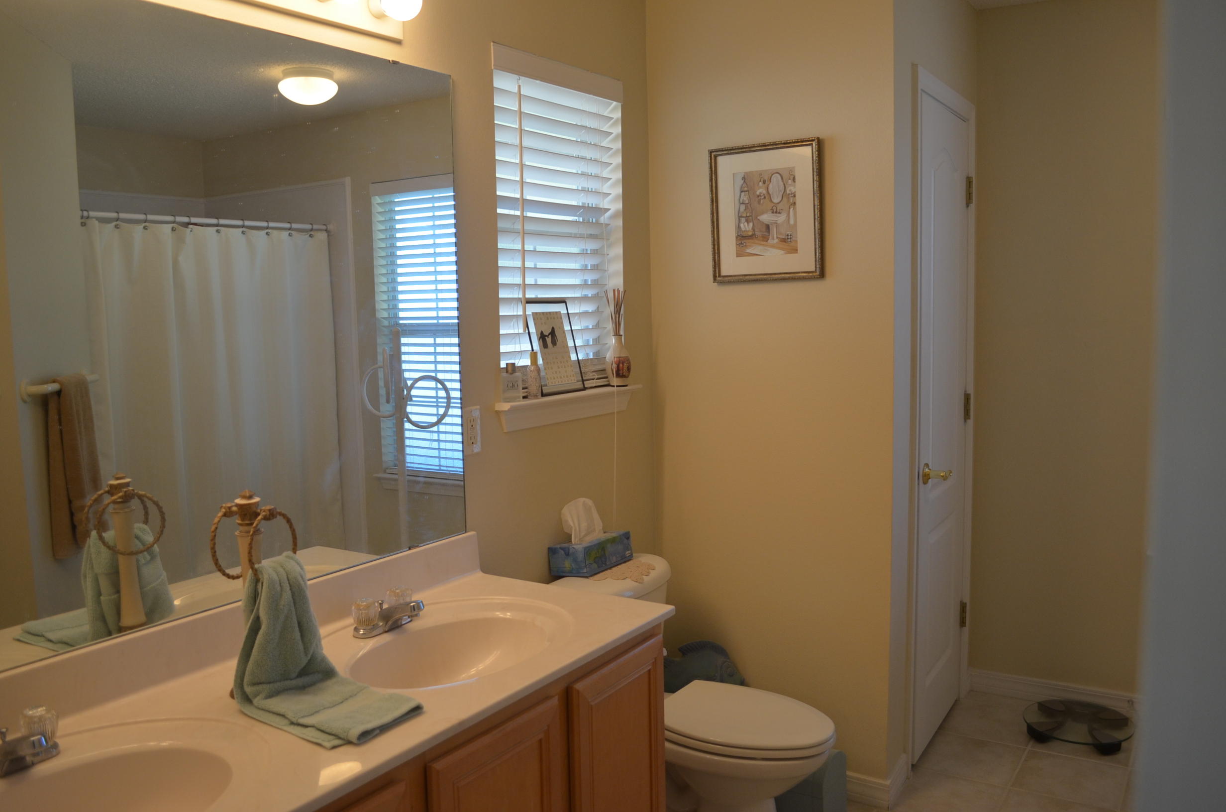 669 East Shipwreck Road Santa Rosa Beach, FL 32459 - Photo 16 of 35 a bathroom with a granite countertop sink toilet and a mirror