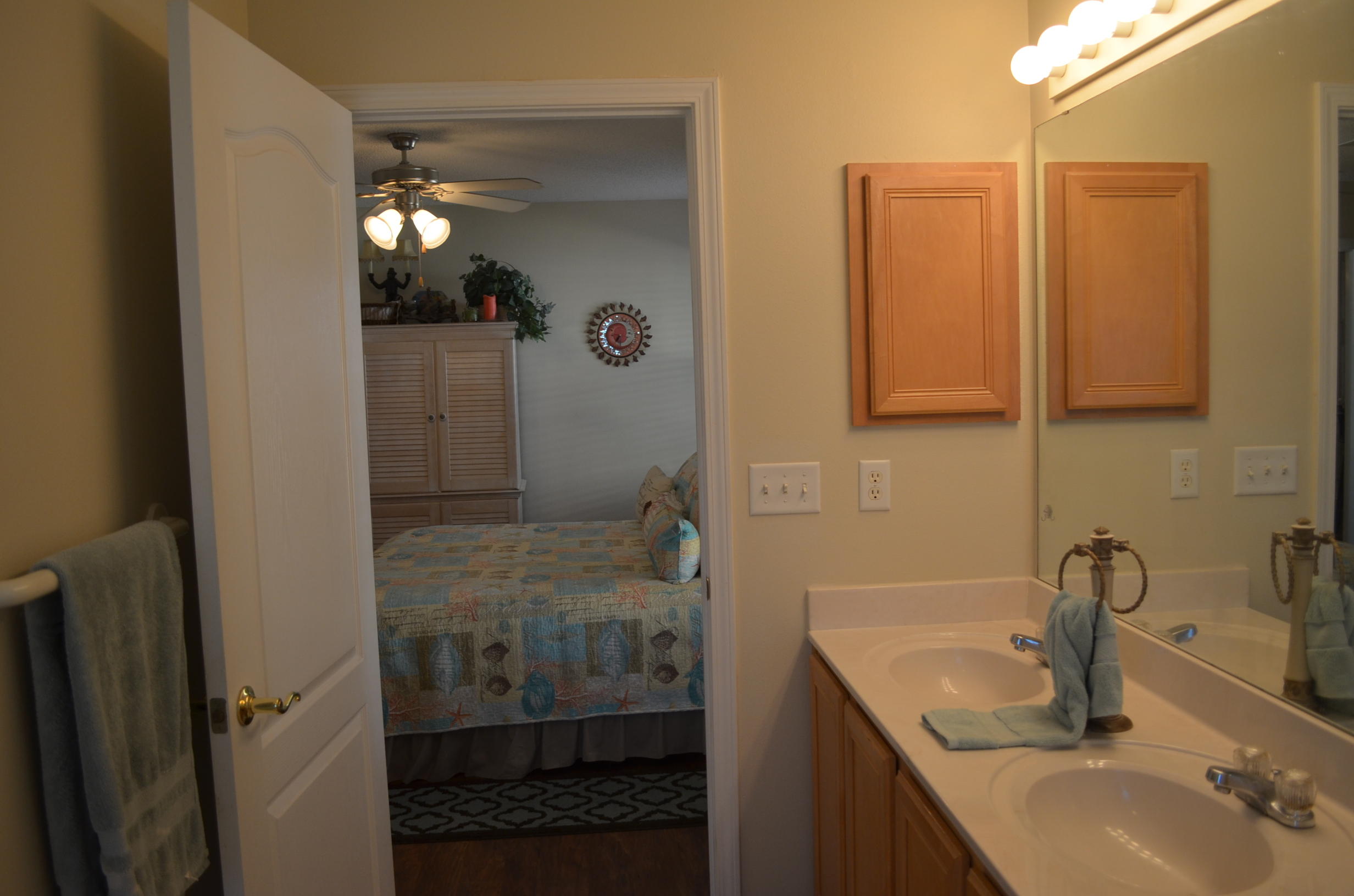 669 East Shipwreck Road Santa Rosa Beach, FL 32459 - Photo 17 of 35 a bathroom with a sink a mirror and shower