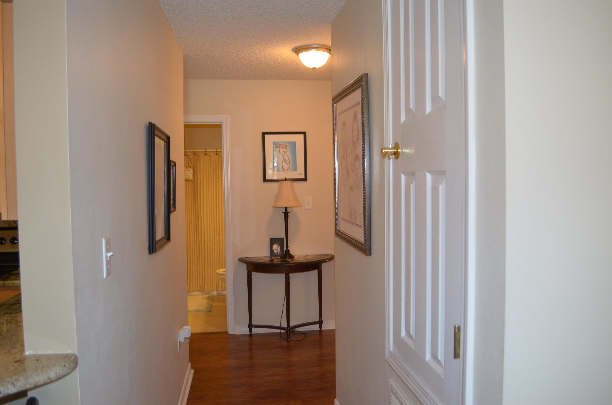 669 East Shipwreck Road Santa Rosa Beach, FL 32459 - Photo 34 of 35 a view of a hallway with paintings on the wall