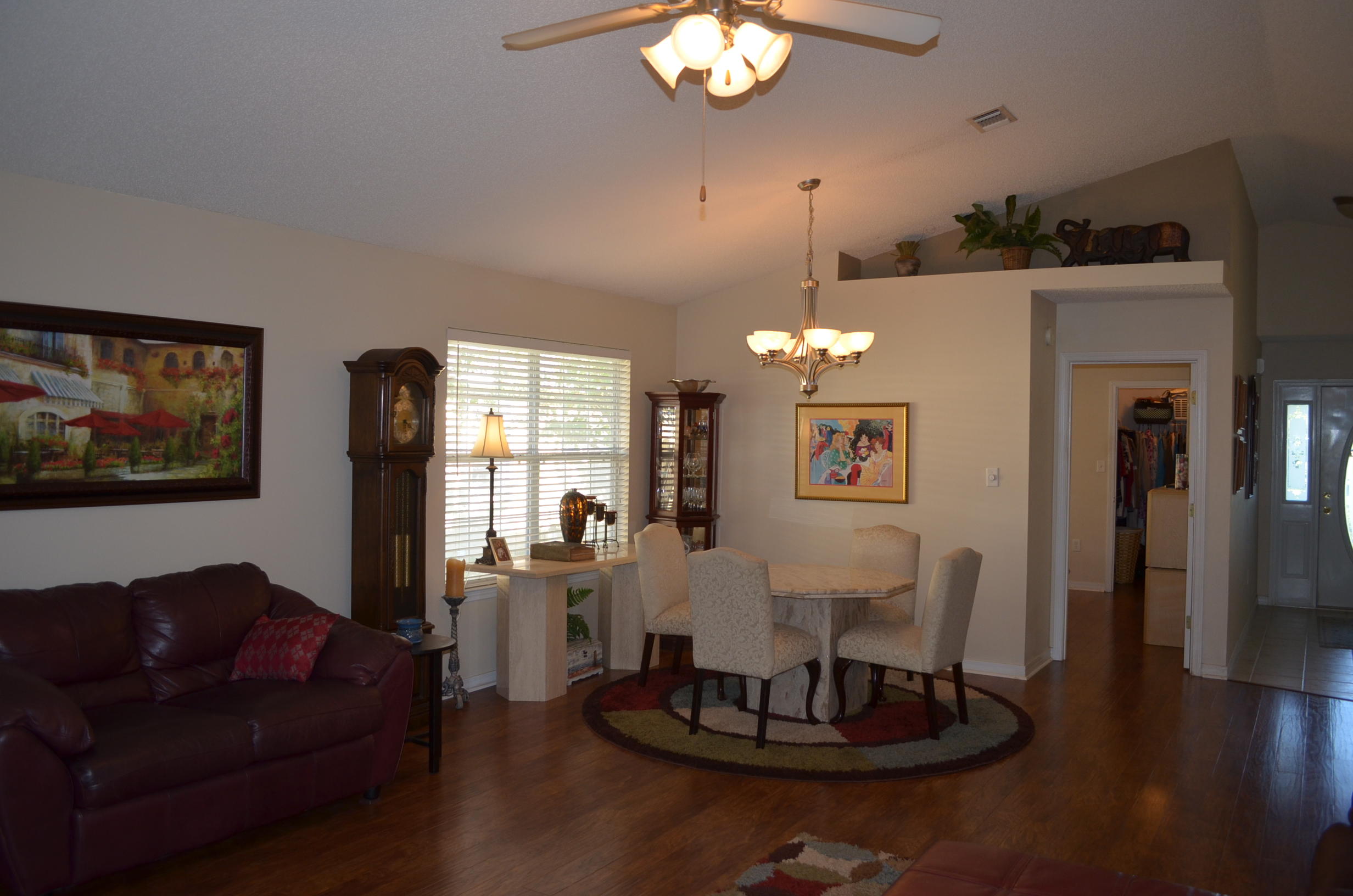 669 East Shipwreck Road Santa Rosa Beach, FL 32459 - Photo 3 of 35 a living room with furniture a chandelier and a dining table