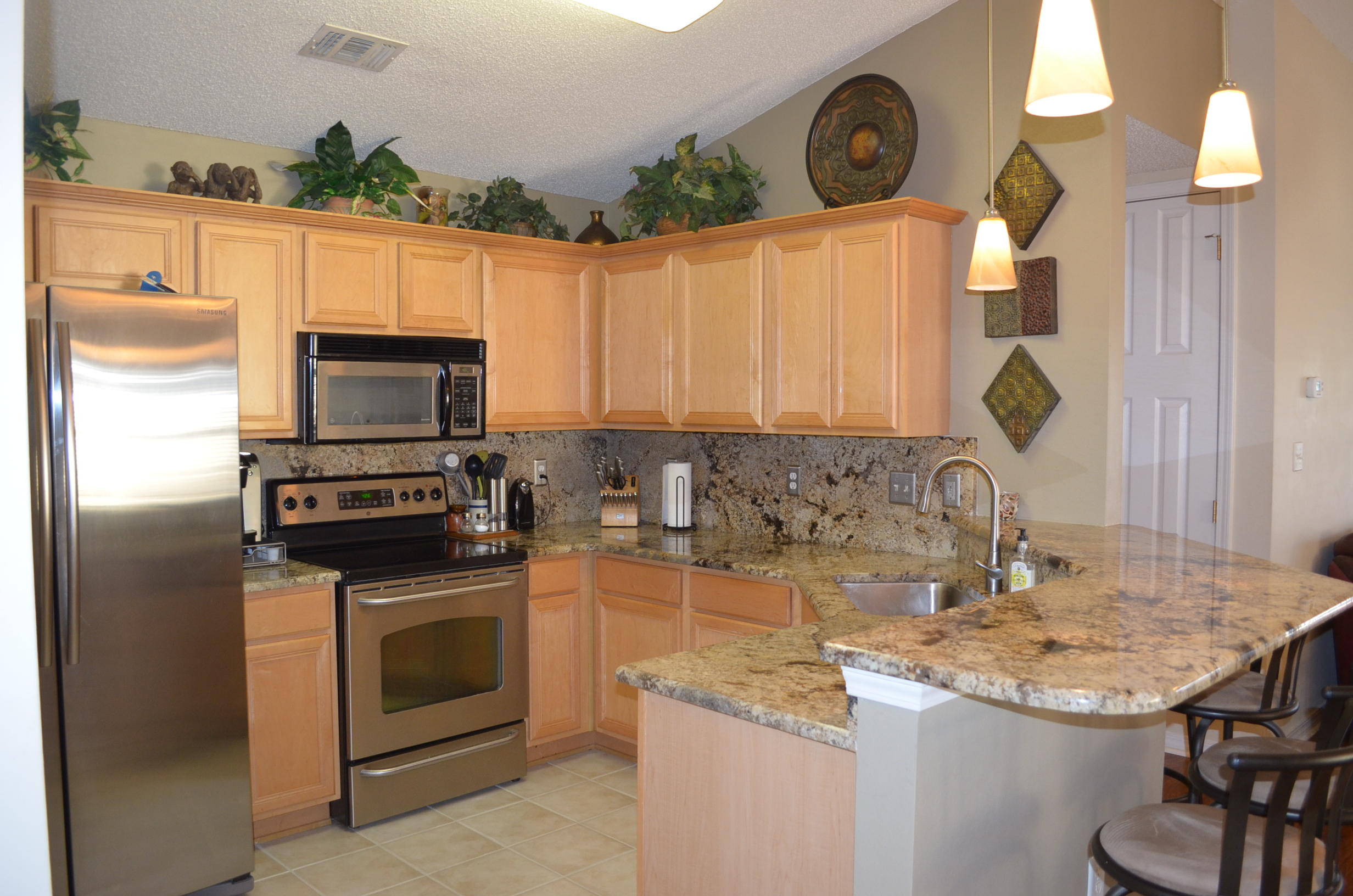 669 East Shipwreck Road Santa Rosa Beach, FL 32459 - Photo 6 of 35 a kitchen with a sink a stove and a microwave