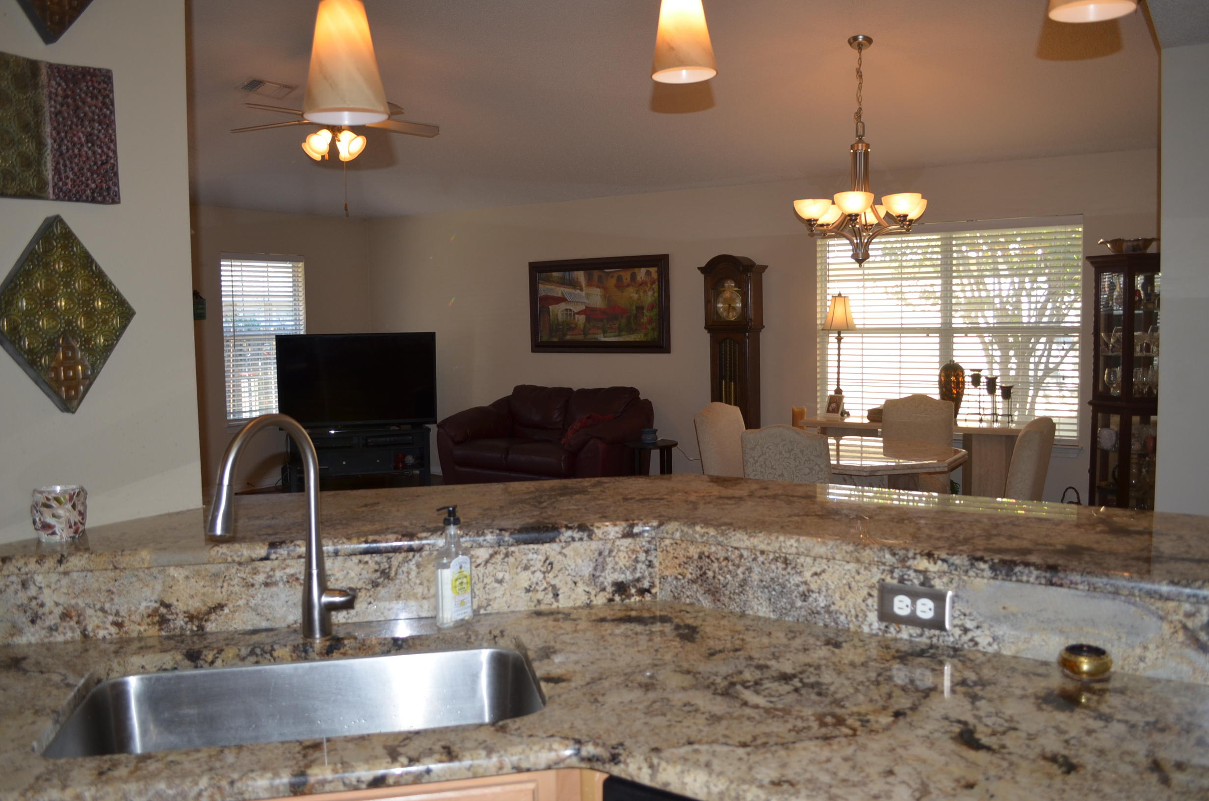 669 East Shipwreck Road Santa Rosa Beach, FL 32459 - Photo 9 of 35 a view of a kitchen with granite countertop a sink counter top space and living room