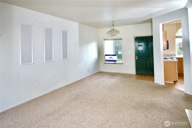 a kitchen with stainless steel appliances a sink a stove cabinets and a window