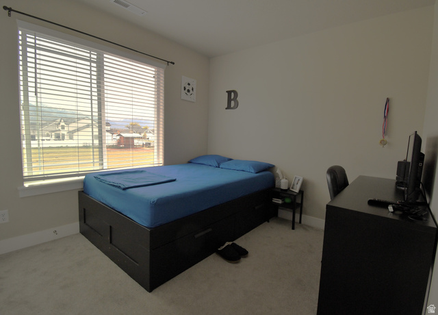 1688 West 200 North Mapleton, UT 84664 - Photo 13 of 18 Bedroom with light carpet and an office area
