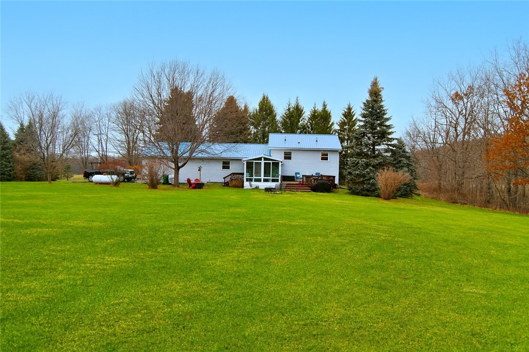 9555 Us Route Hemlock, NY 14466 - Photo 3 of 37 The back of the house features a large deck
