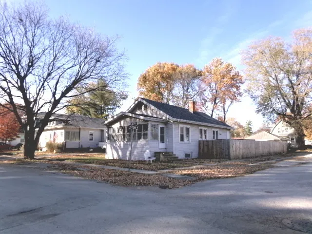 a front view of house with yard and trees
