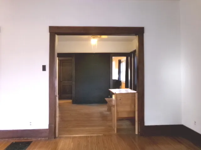 a view of a room with wooden floor and a cabinet