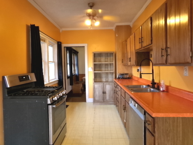 701 West South Street Clinton, IL 61727 - Photo 15 of 29 a kitchen with stainless steel appliances granite countertop a sink stove and refrigerator