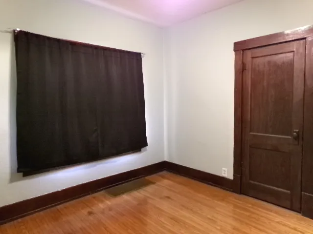 a view of a black door and wooden floor