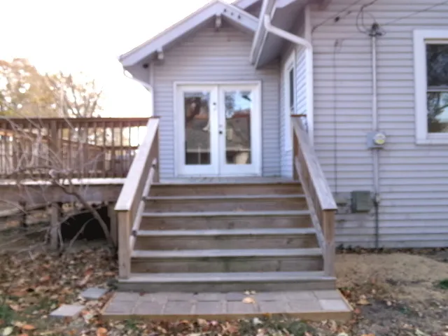 a view of a patio with a table and chairs