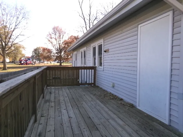 a view of deck with wooden floor and fence and a floor to ceiling window