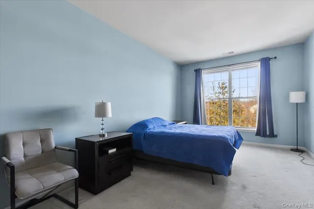 a bathroom with a granite countertop sink a toilet and a mirror