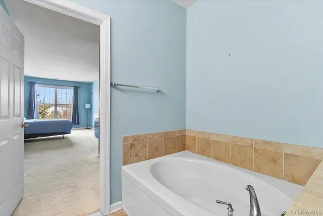 a bathroom with a granite countertop sink a toilet and a mirror