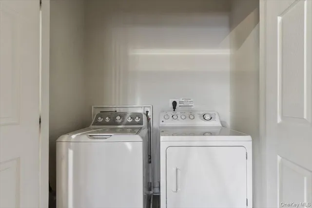 a view of storage and utility room with washer and dryer