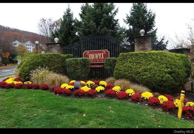 a view of a white house with swimming pool and porch
