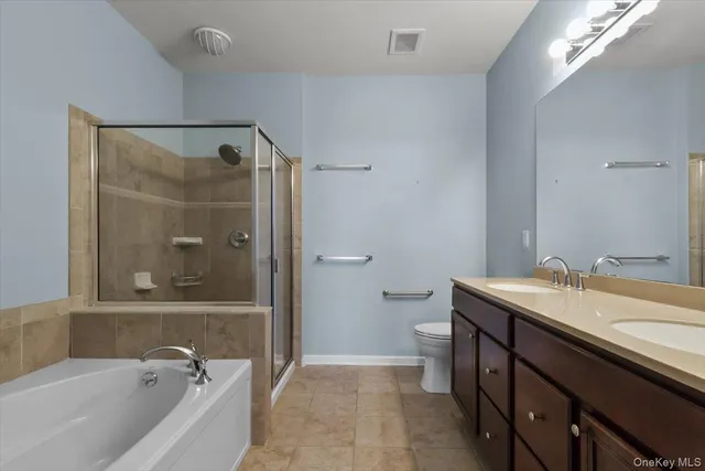 a bathroom with a tub sink toilet and shower
