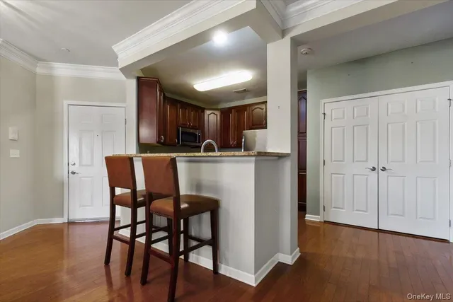 a view of a dining room with furniture wooden floor and chandelier