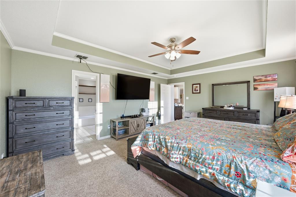 10504 Whitney Trace Drive Waco, TX 76708 - Photo 11 of 24 a bedroom with a bed and a flat screen tv
