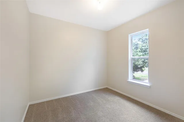 a view of a white house with a front door and a chair