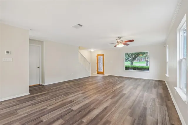 wooden floor in an empty room with a window