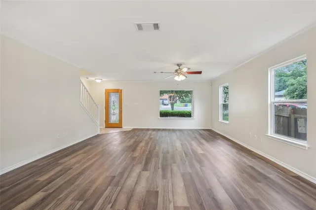 wooden floor in an empty room with a window