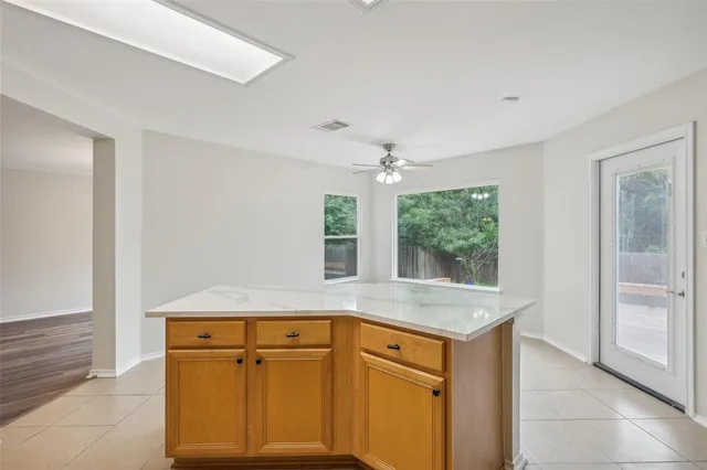 a kitchen with granite countertop a sink and dishwasher with wooden floor