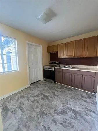 a kitchen with stainless steel appliances granite countertop a stove a sink dishwasher and a refrigerator