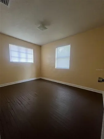 a view of room and hall with wooden floor
