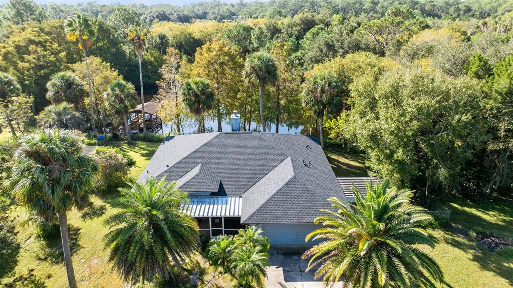 an aerial view of a house with swimming pool and garden space