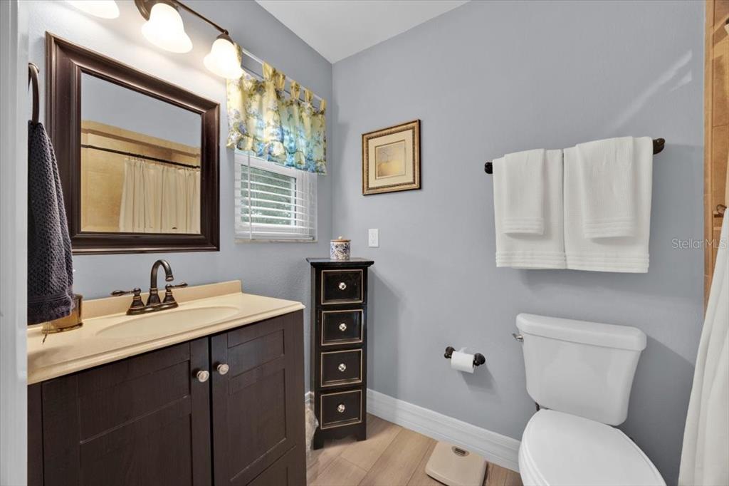 34159 Ridge Manor Boulevard Dade City, FL 33523 - Photo 11 of 33 a bathroom with a toilet sink and mirror