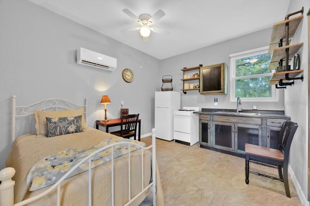 34159 Ridge Manor Boulevard Dade City, FL 33523 - Photo 18 of 33 a bedroom with a bed and a flat screen tv