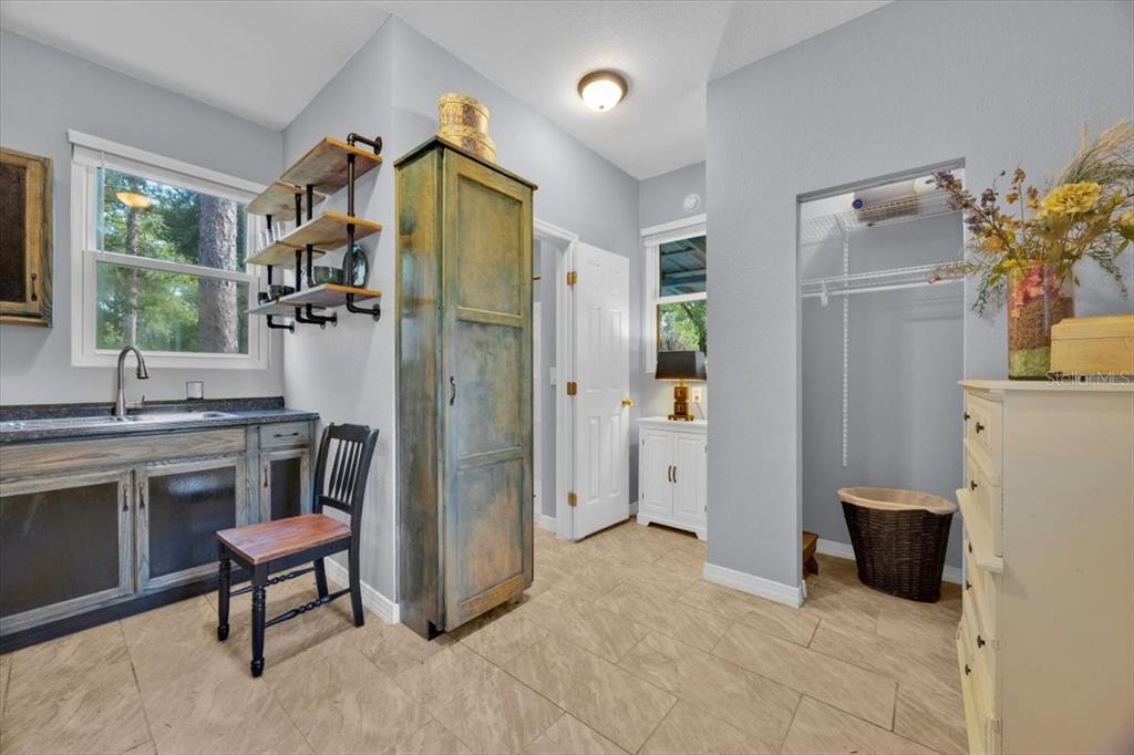 34159 Ridge Manor Boulevard Dade City, FL 33523 - Photo 19 of 33 a spacious bathroom with a granite countertop sink a mirror and a shower