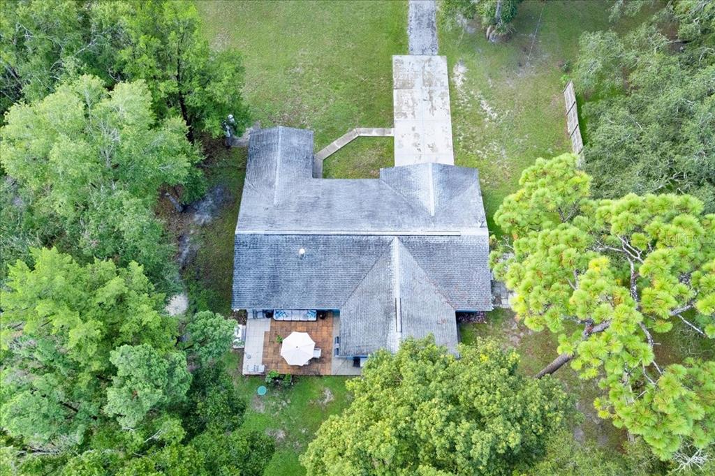 34159 Ridge Manor Boulevard Dade City, FL 33523 - Photo 27 of 33 an aerial view of a house with table and garden