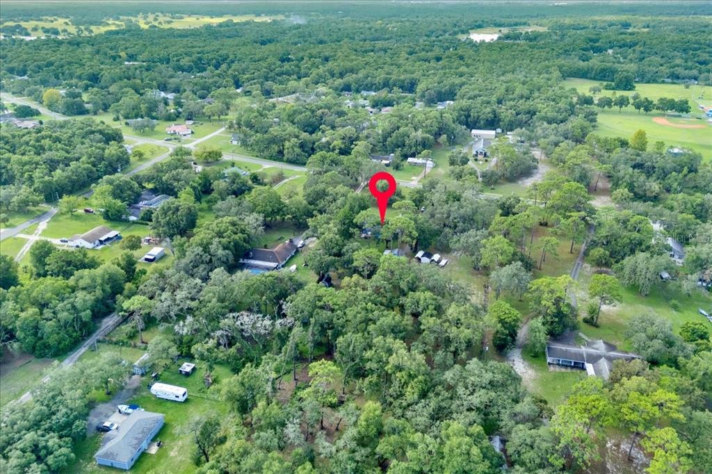 34159 Ridge Manor Boulevard Dade City, FL 33523 - Photo 28 of 33 an aerial view of residential houses with outdoor space and trees
