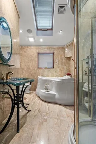 a bathroom with a granite countertop sink a mirror and a shower