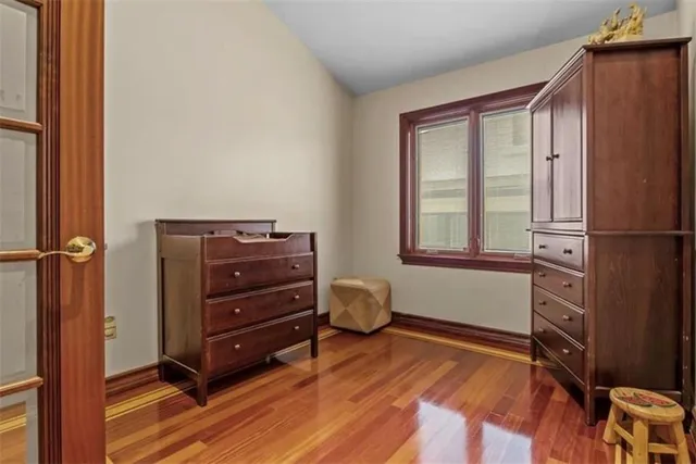 a room with a dresser and a window