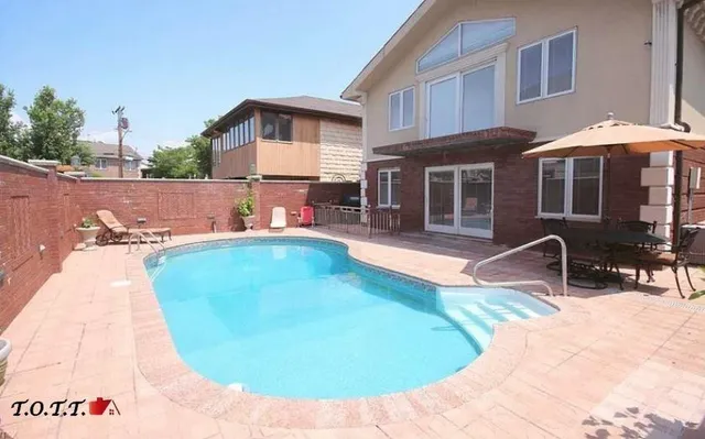 a backyard of a house with table and chairs