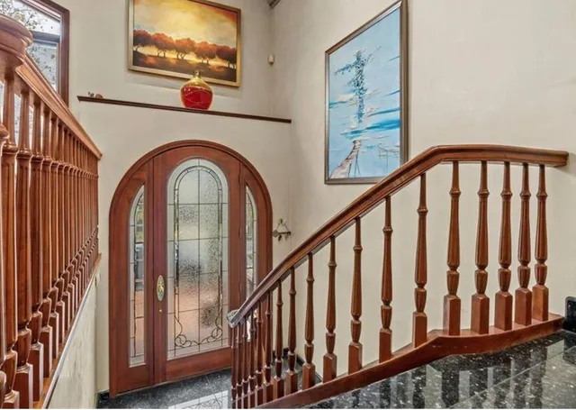 a view of staircase with wooden floor and stairs