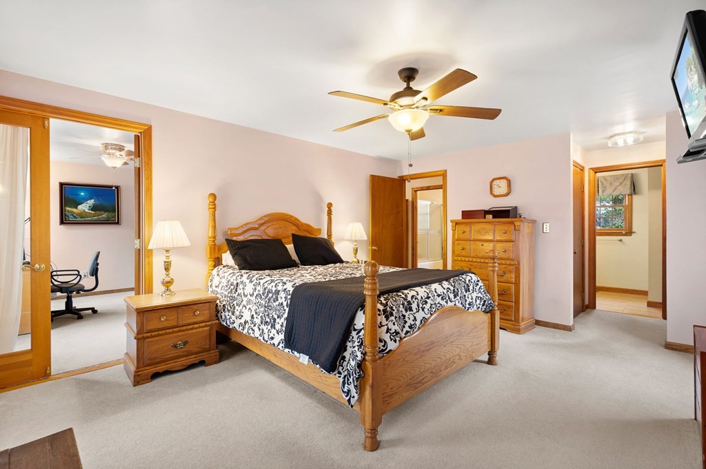 1 Beacon Hill Road Marblehead, MA 01945 - Photo 19 of 30 a bedroom with a bed and a chandelier