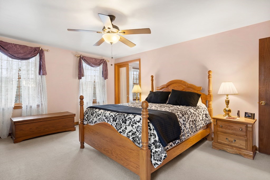 1 Beacon Hill Road Marblehead, MA 01945 - Photo 20 of 30 a bedroom with a bed and a chandelier