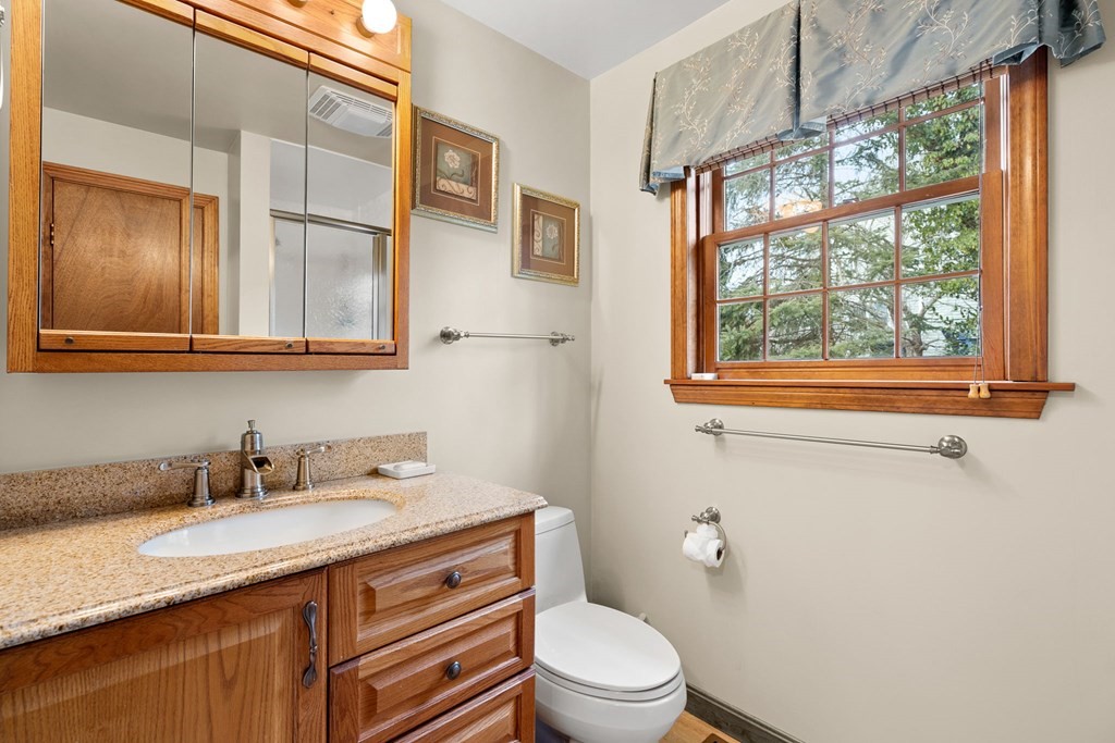 1 Beacon Hill Road Marblehead, MA 01945 - Photo 21 of 30 a bathroom with a granite countertop sink toilet and a window