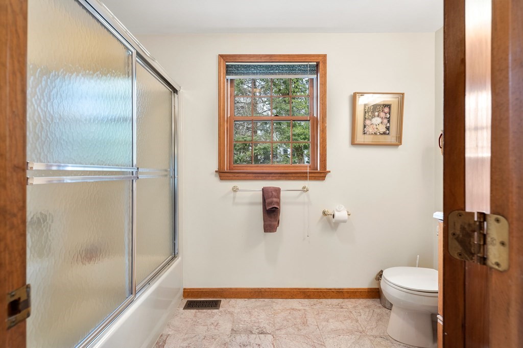 1 Beacon Hill Road Marblehead, MA 01945 - Photo 24 of 30 a bathroom with a granite countertop toilet a sink and shower