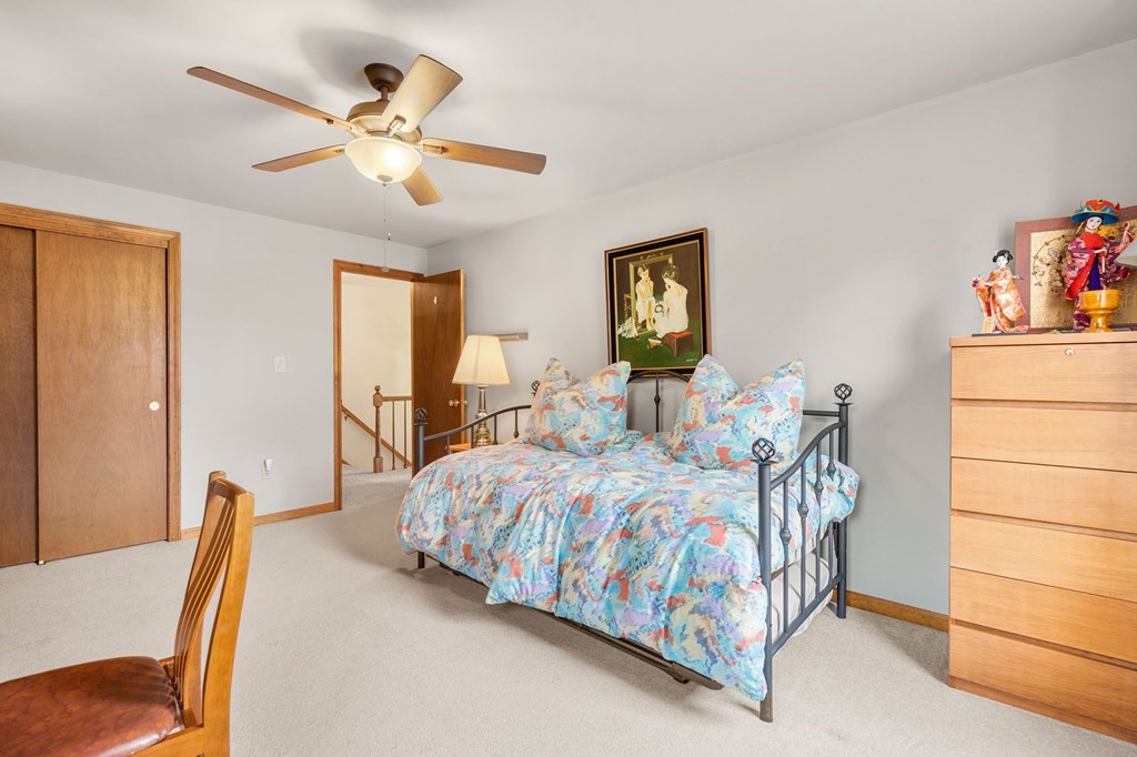 1 Beacon Hill Road Marblehead, MA 01945 - Photo 25 of 30 a bedroom with a bed and a chandelier