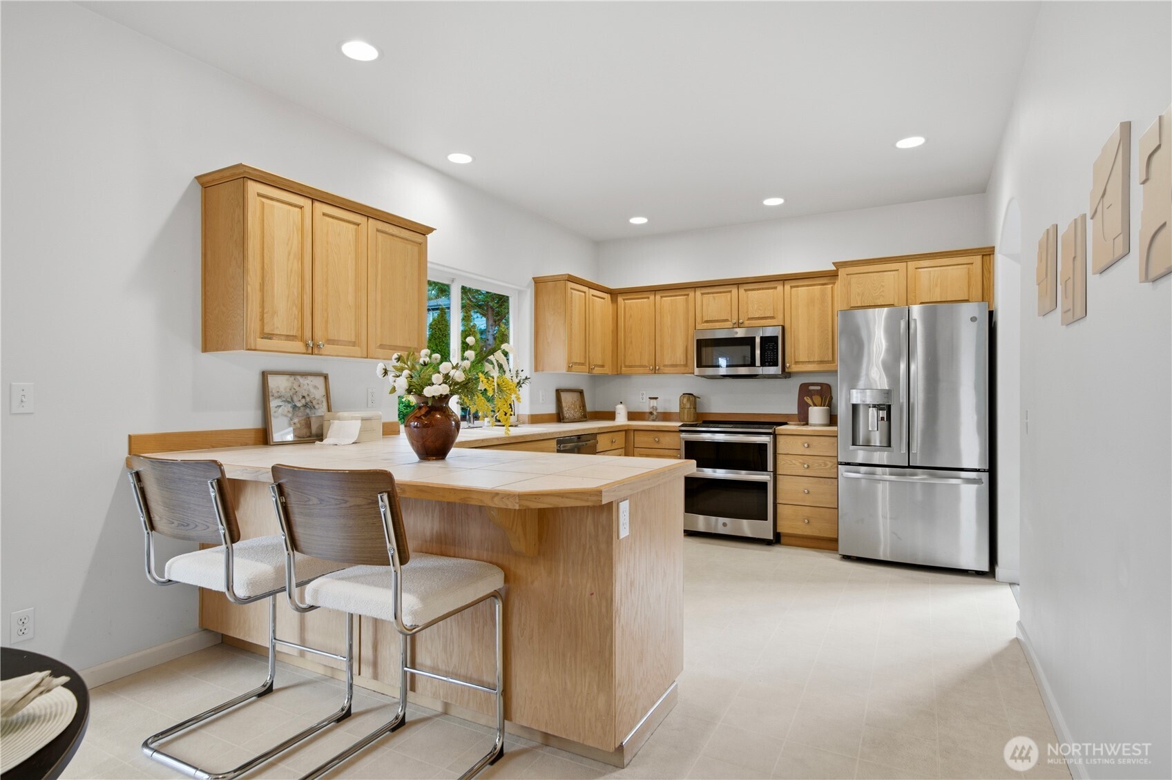 1611 242nd Street Southeast Bothell, WA 98021 - Photo 15 of 39 a kitchen with kitchen island white cabinets and stainless steel appliances
